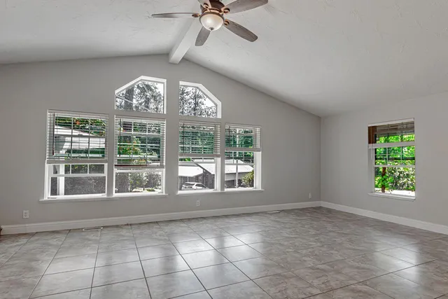 a kitchen with granite countertop white cabinets and white stainless steel appliances