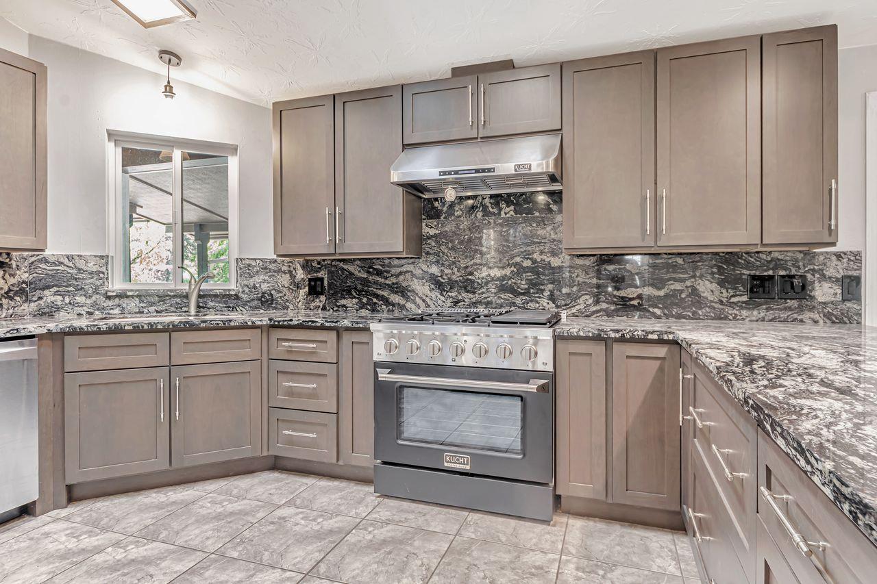571 B Lane Applegate, CA 95703 - Photo 31 of 85 a kitchen with stainless steel appliances granite countertop a sink stove and cabinets