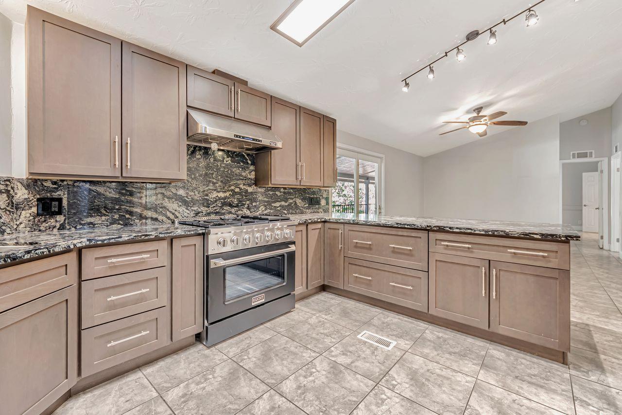 571 B Lane Applegate, CA 95703 - Photo 32 of 85 a kitchen with granite countertop a sink cabinets stainless steel appliances and a counter space