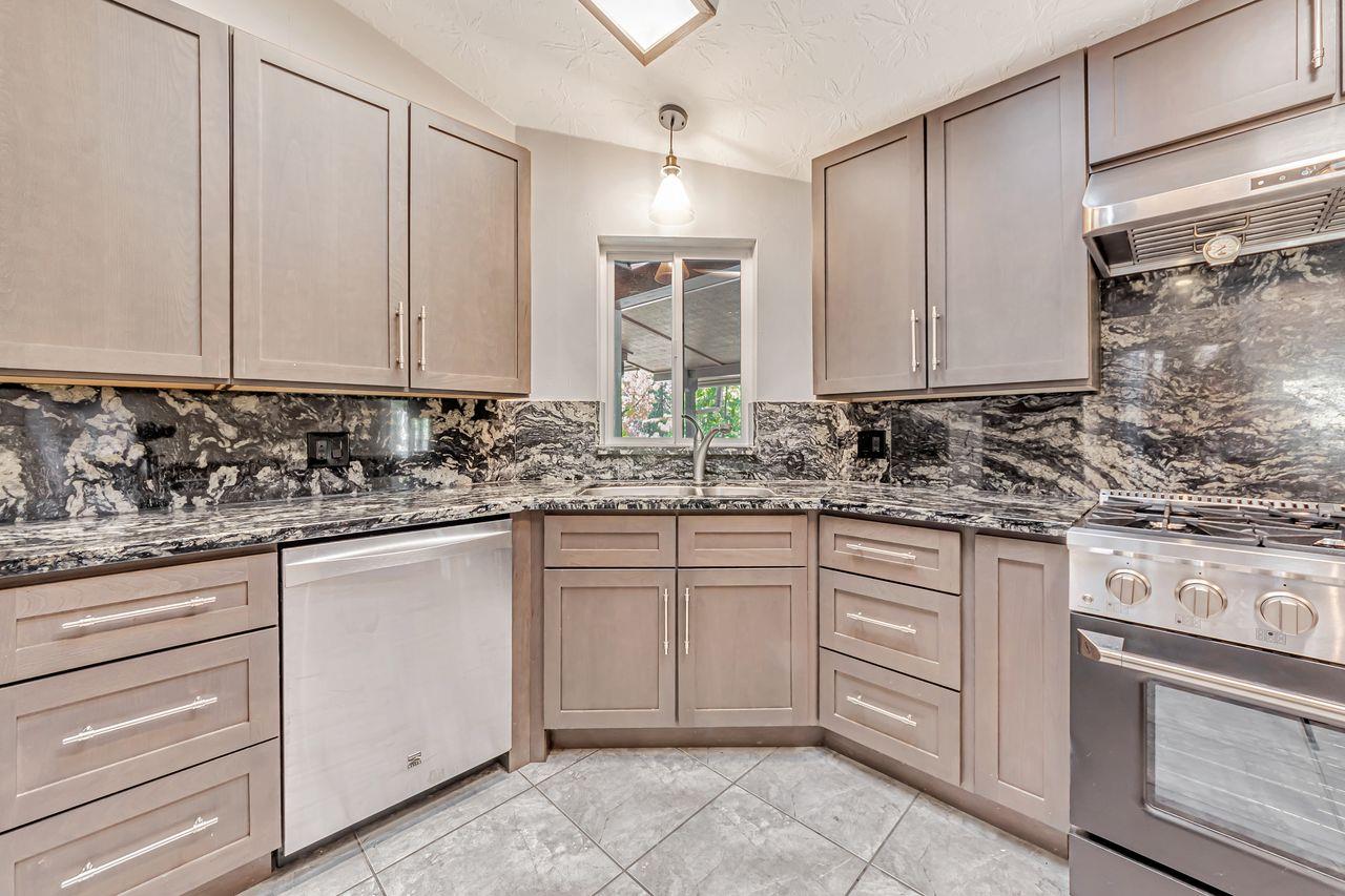 571 B Lane Applegate, CA 95703 - Photo 34 of 85 a kitchen with granite countertop white cabinets sink and stainless steel appliances