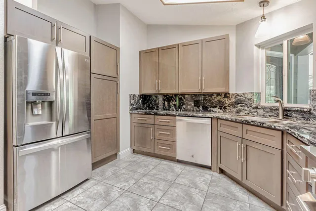 a view of a bathroom with a shower and a ceiling fan