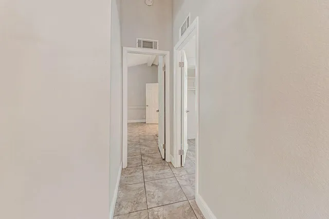 a view of hallway with furniture and a refrigerator