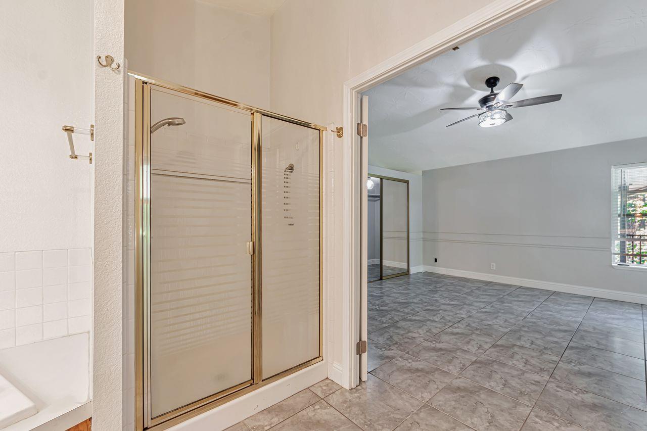 571 B Lane Applegate, CA 95703 - Photo 58 of 85 a view of a bathroom with a shower and a ceiling fan