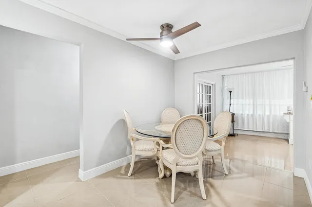 a view of a white house with a big yard and a large tree