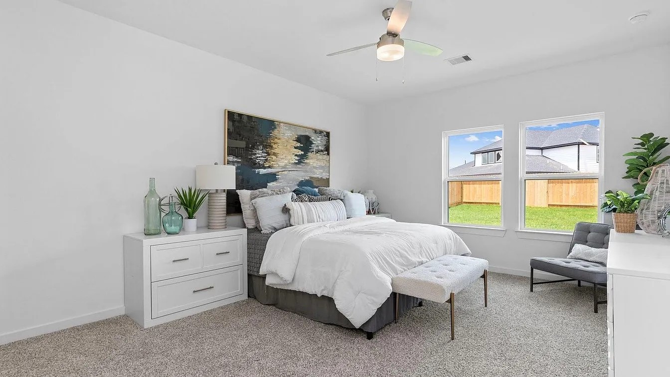 3702 Birtley Bnd Way Fulshear, TX 77441 - Photo 11 of 26 a bedroom with a bed and a flat tv screen