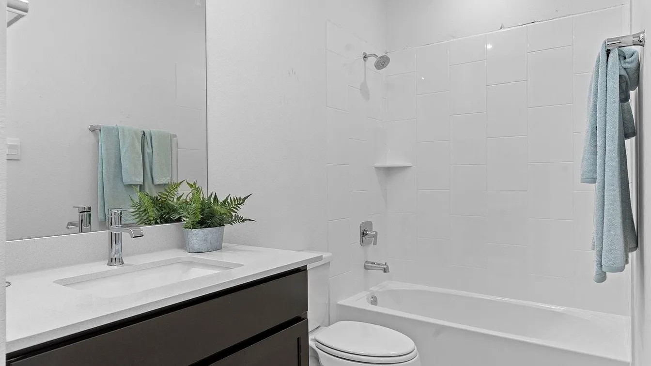 3702 Birtley Bnd Way Fulshear, TX 77441 - Photo 15 of 26 a bathroom with a granite countertop sink toilet and shower