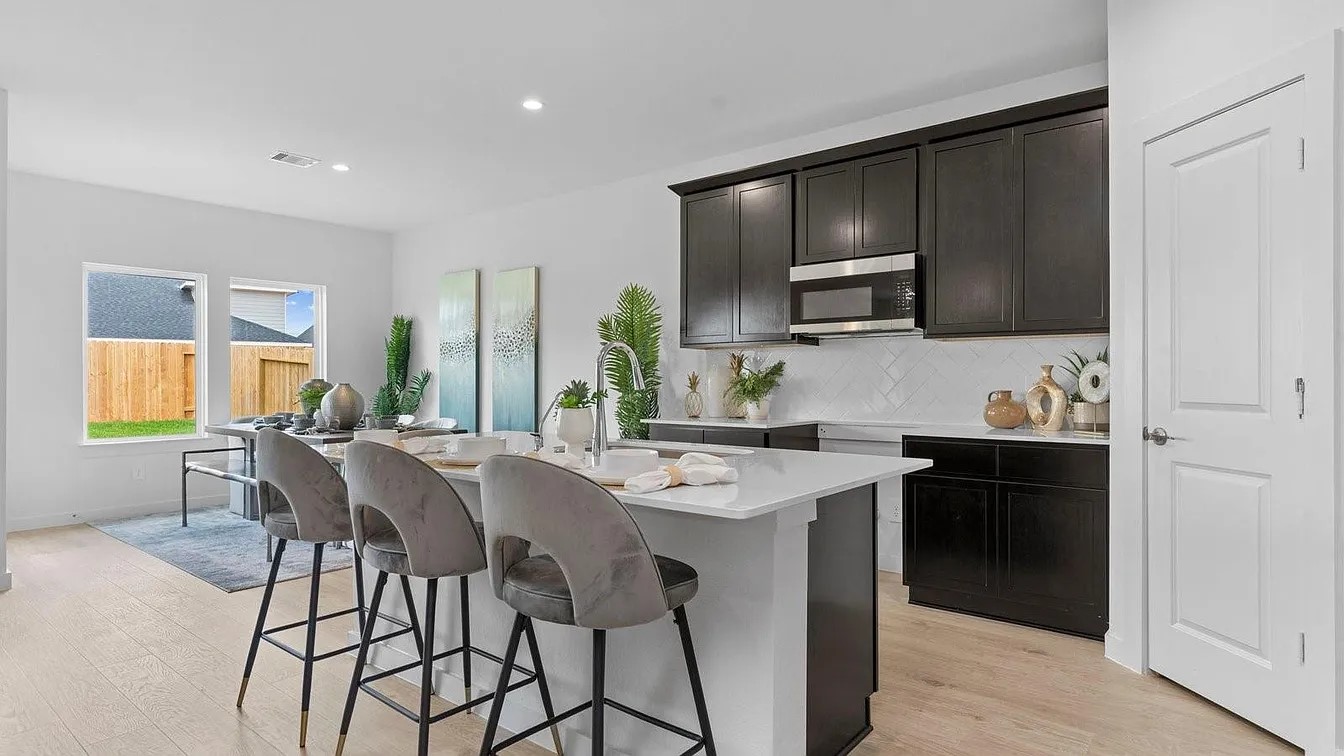 3702 Birtley Bnd Way Fulshear, TX 77441 - Photo 8 of 26 a kitchen with a stove a sink and a refrigerator