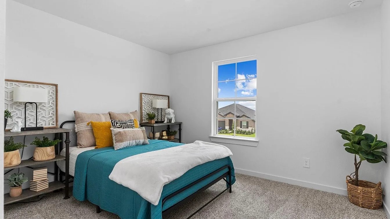 3702 Birtley Bnd Way Fulshear, TX 77441 - Photo 9 of 26 a bedroom with a bed table and window