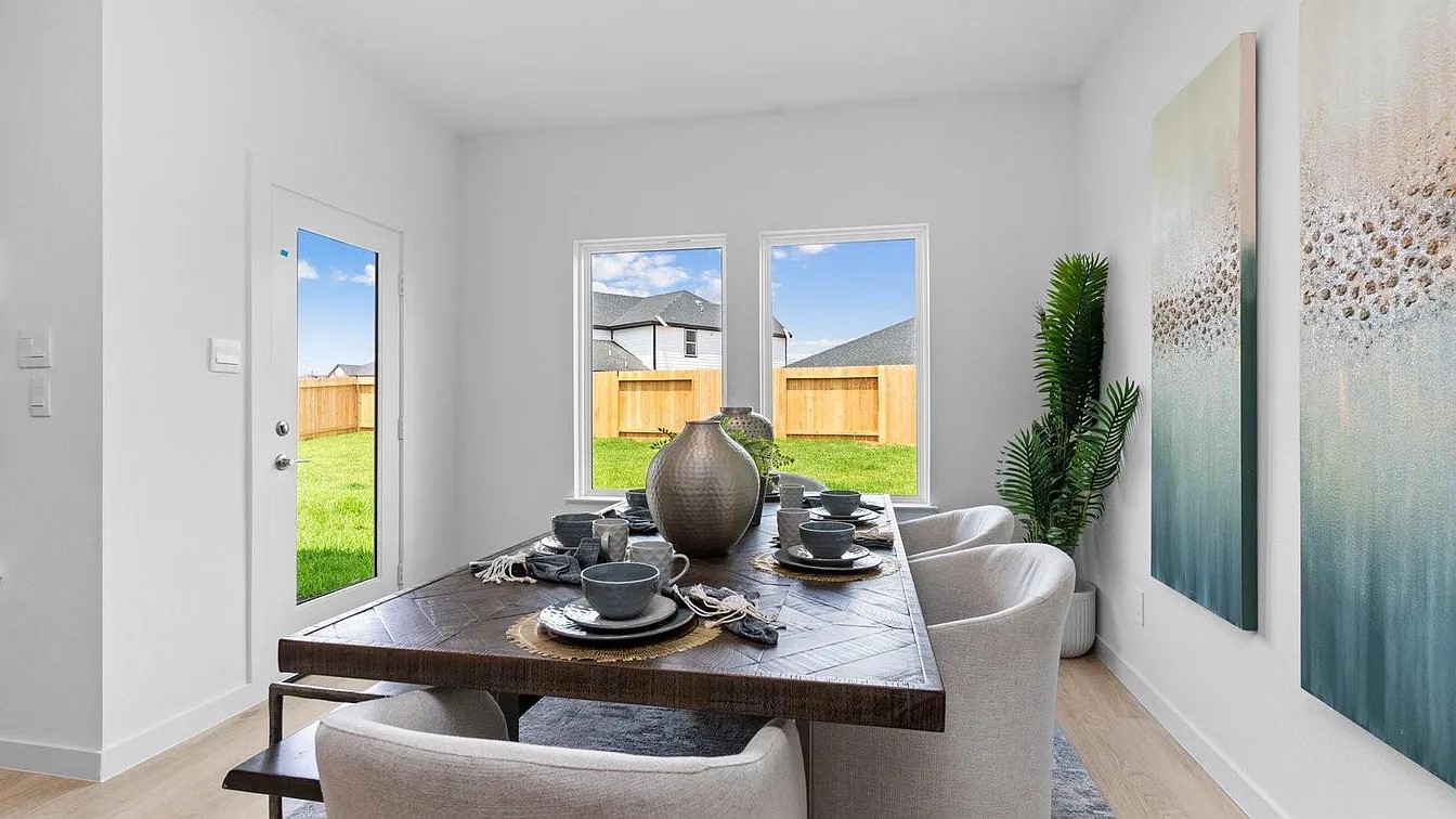 3702 Birtley Bnd Way Fulshear, TX 77441 - Photo 10 of 26 a view of a dining room with furniture and a potted plant
