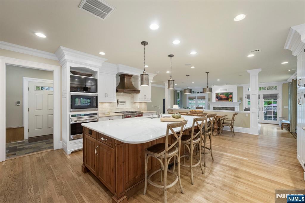 203 Heights Road Ridgewood, NJ 07450 - Photo 5 of 41 a large kitchen with a table and chairs in it