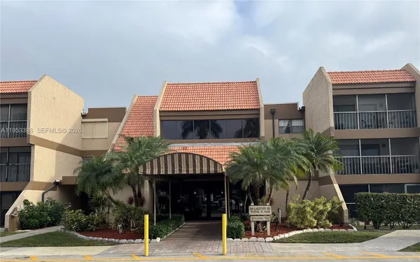 a front view of a house with palm tree