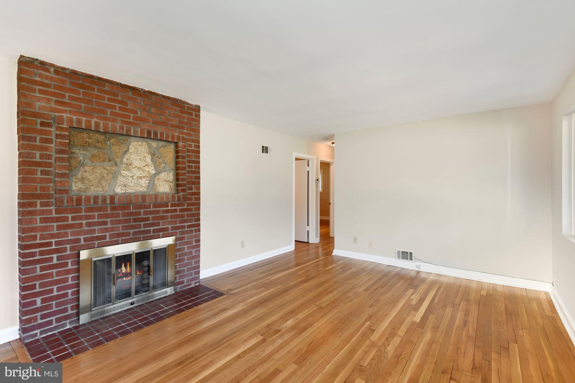 6705 Adelphi Road University Park, MD 20782 - Photo 4 of 35 Greeted with a wood burning fireplace