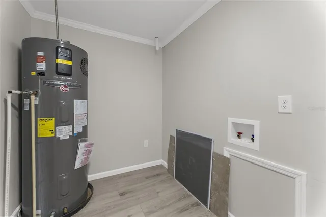 a view of a storage and utility room with wooden floor