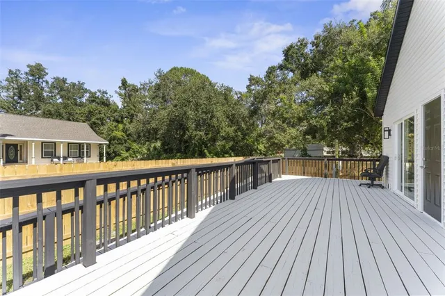 a view of a wooden deck with a yard
