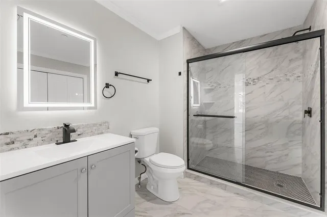 a bathroom with a sink toilet and shower