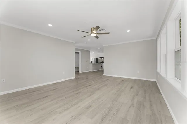 wooden floor in an empty room with a window