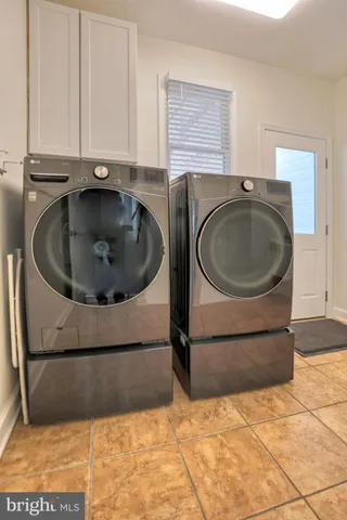 a dining room with furniture a chandelier and wooden floor
