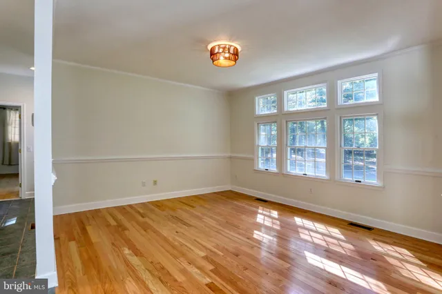 a living room with fireplace furniture and a floor to ceiling window