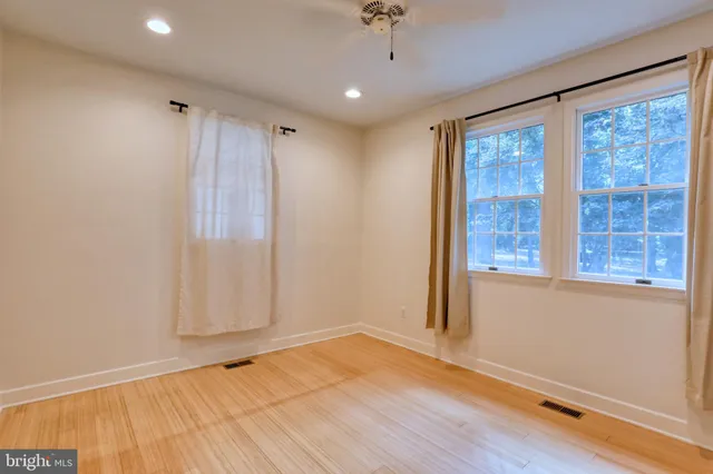 a bathroom with a double vanity sink mirror and toilet