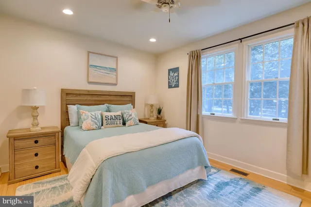 a view of a room with window ceiling fan and kitchen view