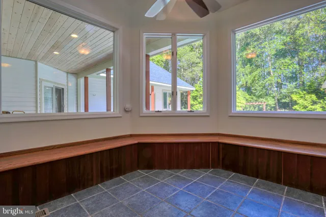 a large white kitchen with a large window