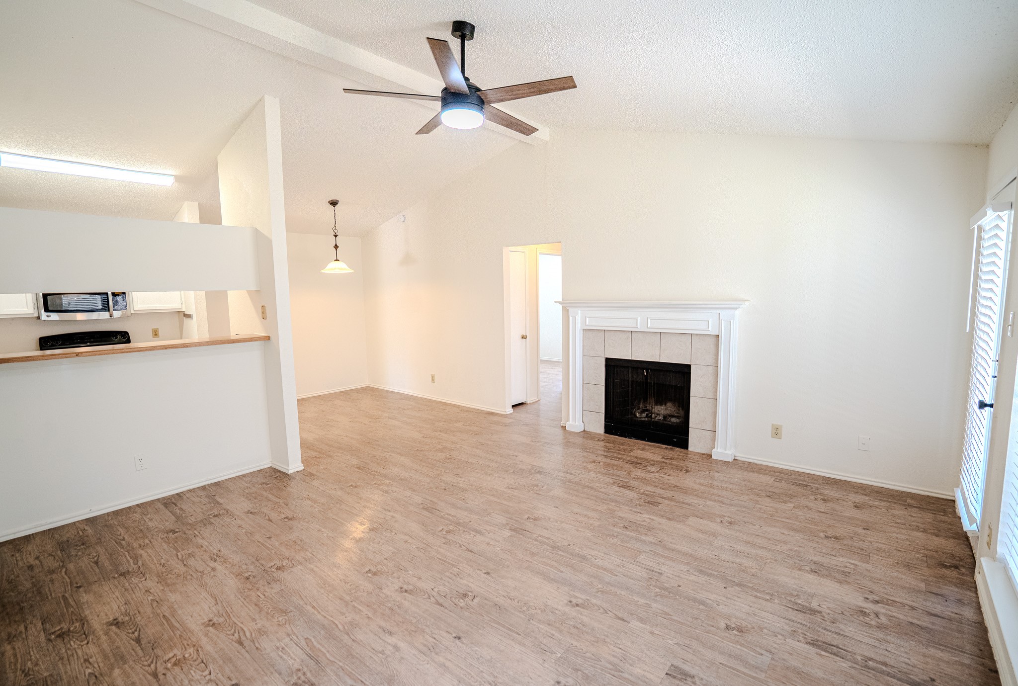 517 Cutty Trail, Unit B Lakeway, TX 78734 - Photo 2 of 16 A living space offers high ceilings, a fireplace, and elegant flooring.
