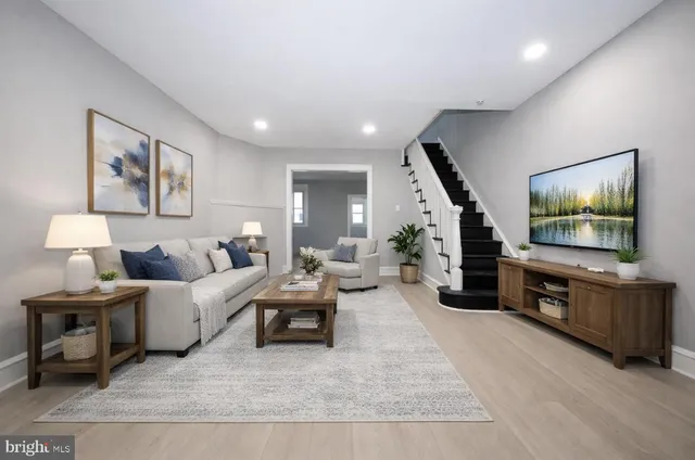 a living room with furniture and a flat screen tv
