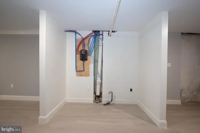 a view of a room with wooden floor