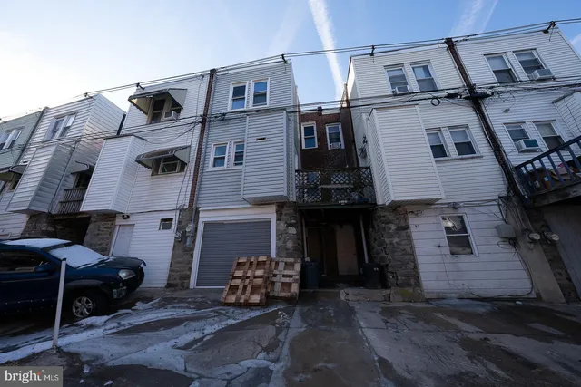 a front view of a house with chairs