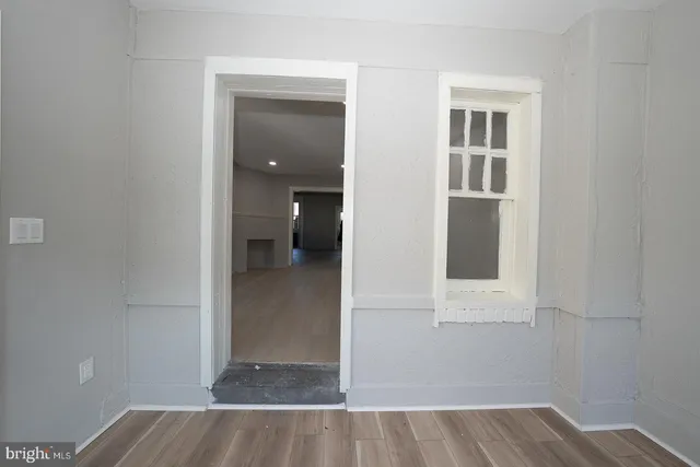 an empty room with windows and entrance