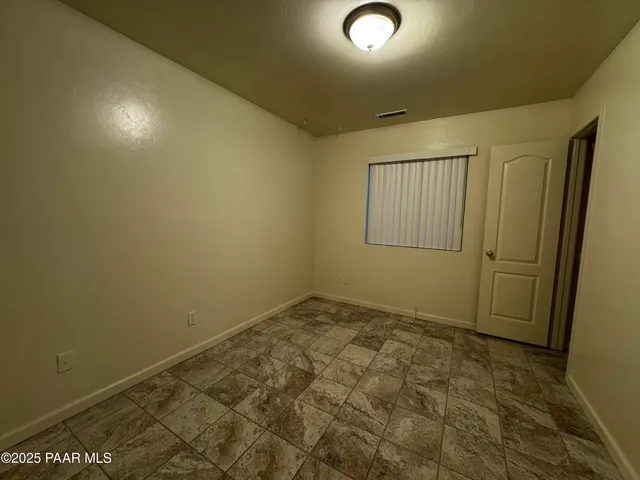 an empty room with a empty space and windows