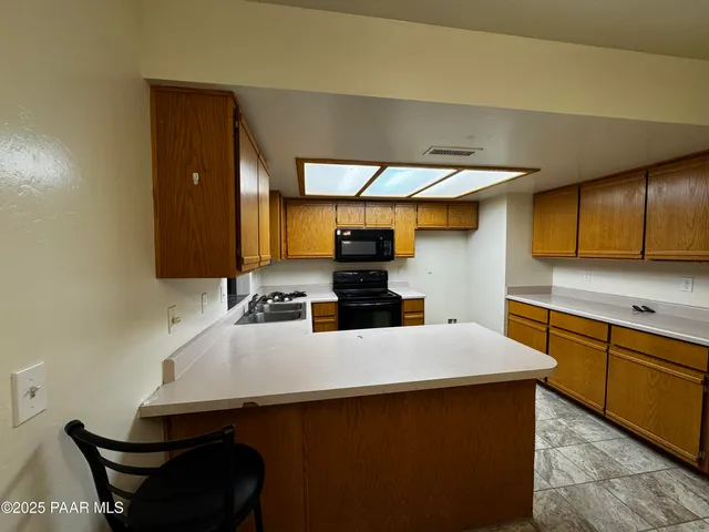 a kitchen with a table and chairs in it