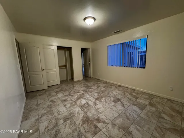 an empty room with an entryway and a cabinet