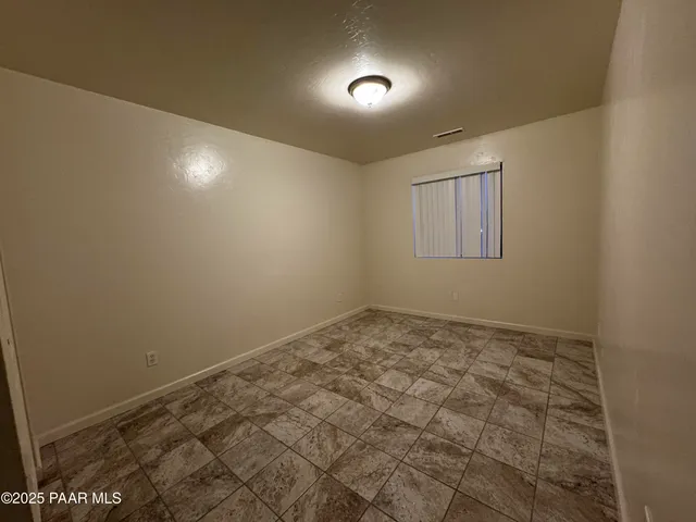 an empty room with a empty space and windows