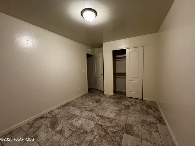 an empty room with closet area