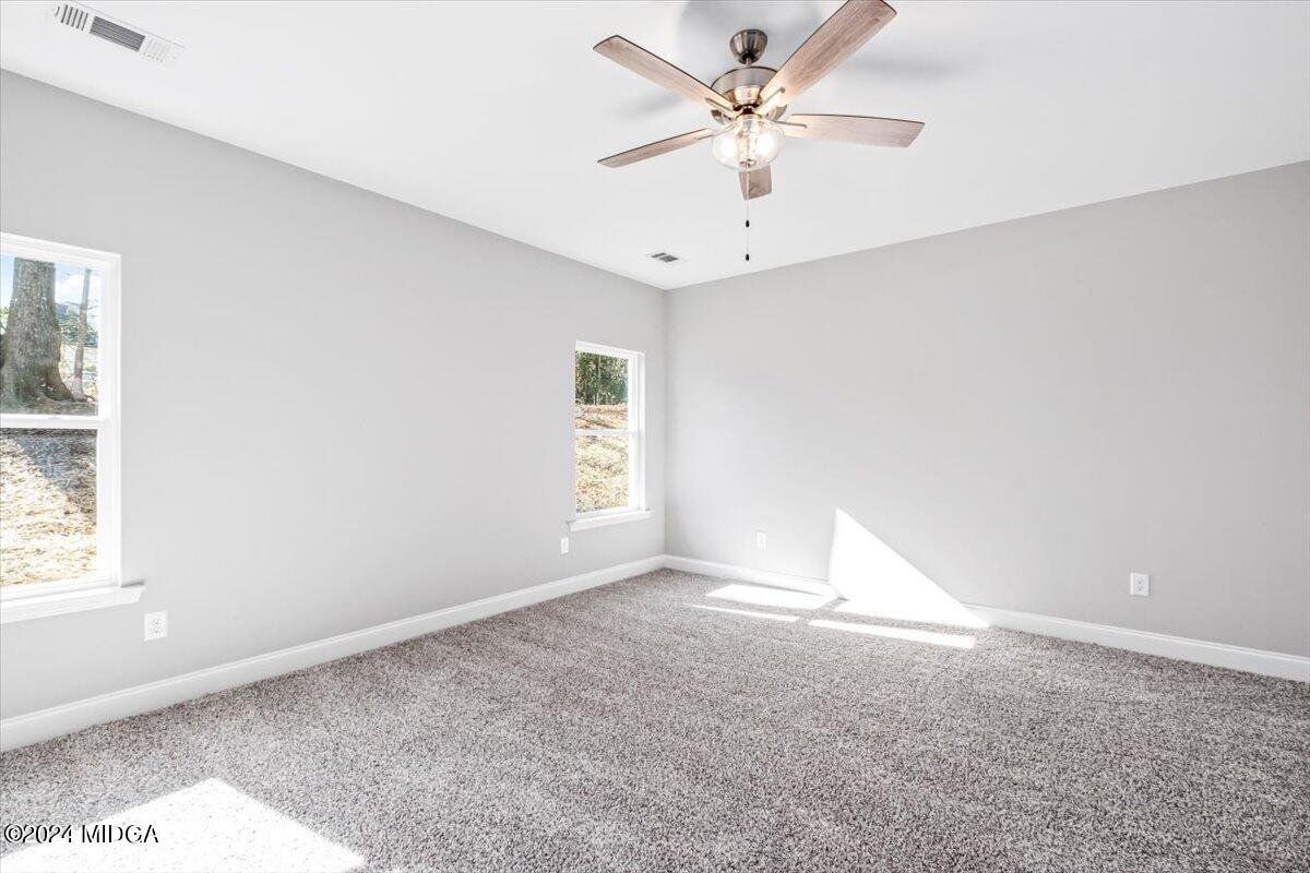 364 Walnut Grove Road Gray, GA 31032 - Photo 12 of 27 an empty room with a window and a ceiling fan
