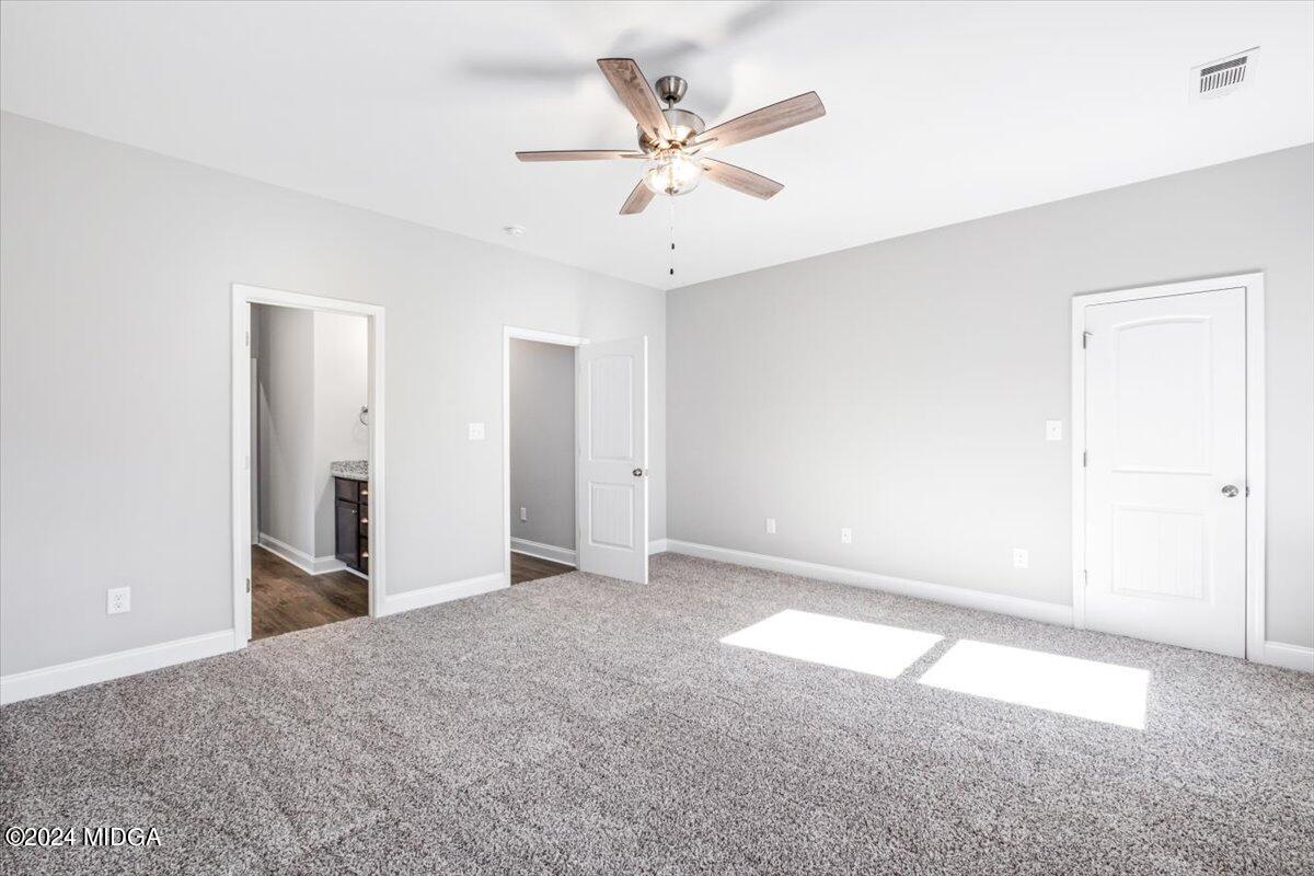364 Walnut Grove Road Gray, GA 31032 - Photo 13 of 27 an empty room with closet and ceiling fan