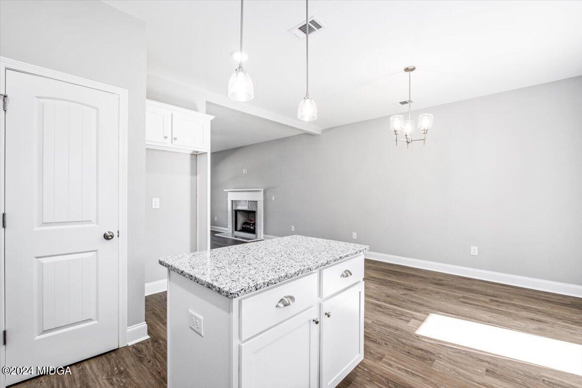 364 Walnut Grove Road Gray, GA 31032 - Photo 10 of 27 a kitchen with a sink chandelier and wooden floor