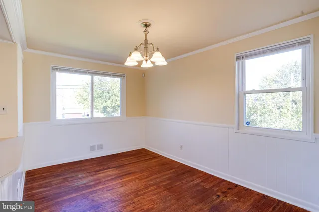 a view of livingroom with chandelier and wooden floor