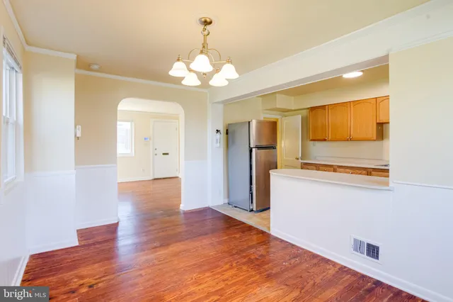 a kitchen with kitchen island granite countertop a sink cabinets and refrigerator