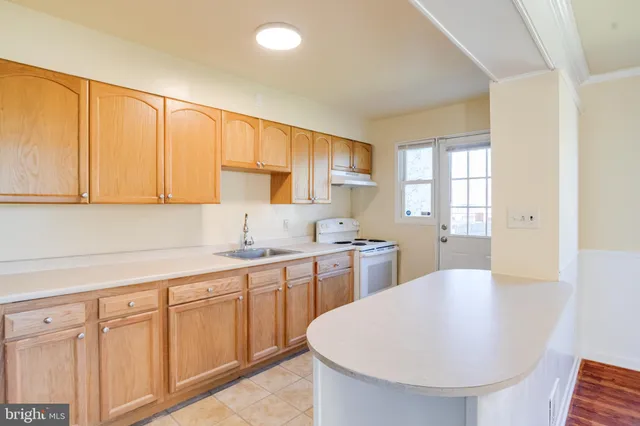 a kitchen with sink cabinets and outdoor view