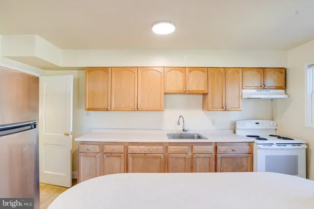 a kitchen with a refrigerator and a sink