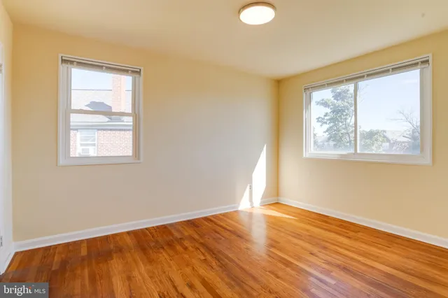 a view of empty room with wooden floor