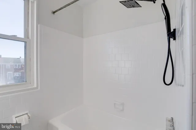 a view of room with window and wooden floor