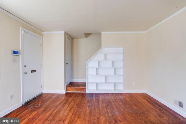 a kitchen with stainless steel appliances granite countertop a stove and a wooden floors