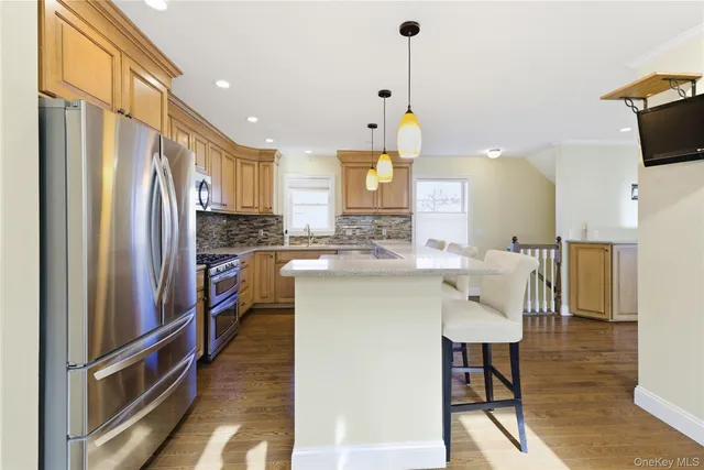a kitchen with stainless steel appliances granite countertop a sink a stove and cabinets