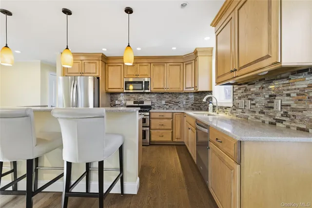 a view of a kitchen with furniture and wooden floor