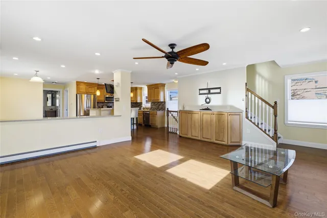 a kitchen with cabinets and wooden floors
