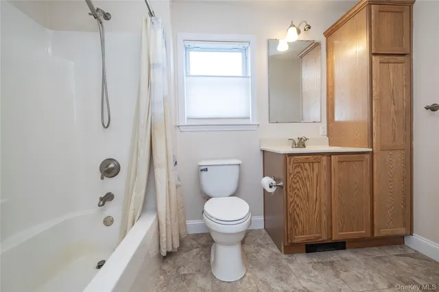 a bathroom with a toilet and a bathtub