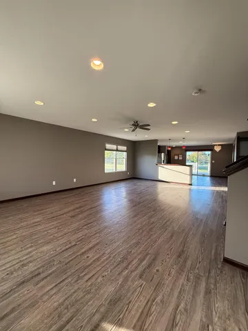 a kitchen with stainless steel appliances wooden floors and wooden cabinets